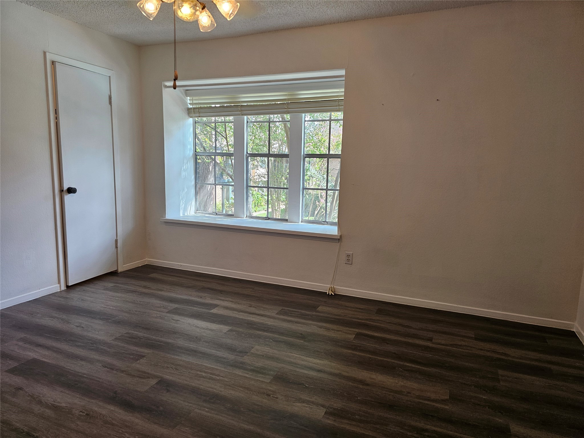 8287 Kingsbrook Road, Unit 268 Houston, TX 77024 - Photo 15 of 50 a view of an empty room with wooden floor and a window