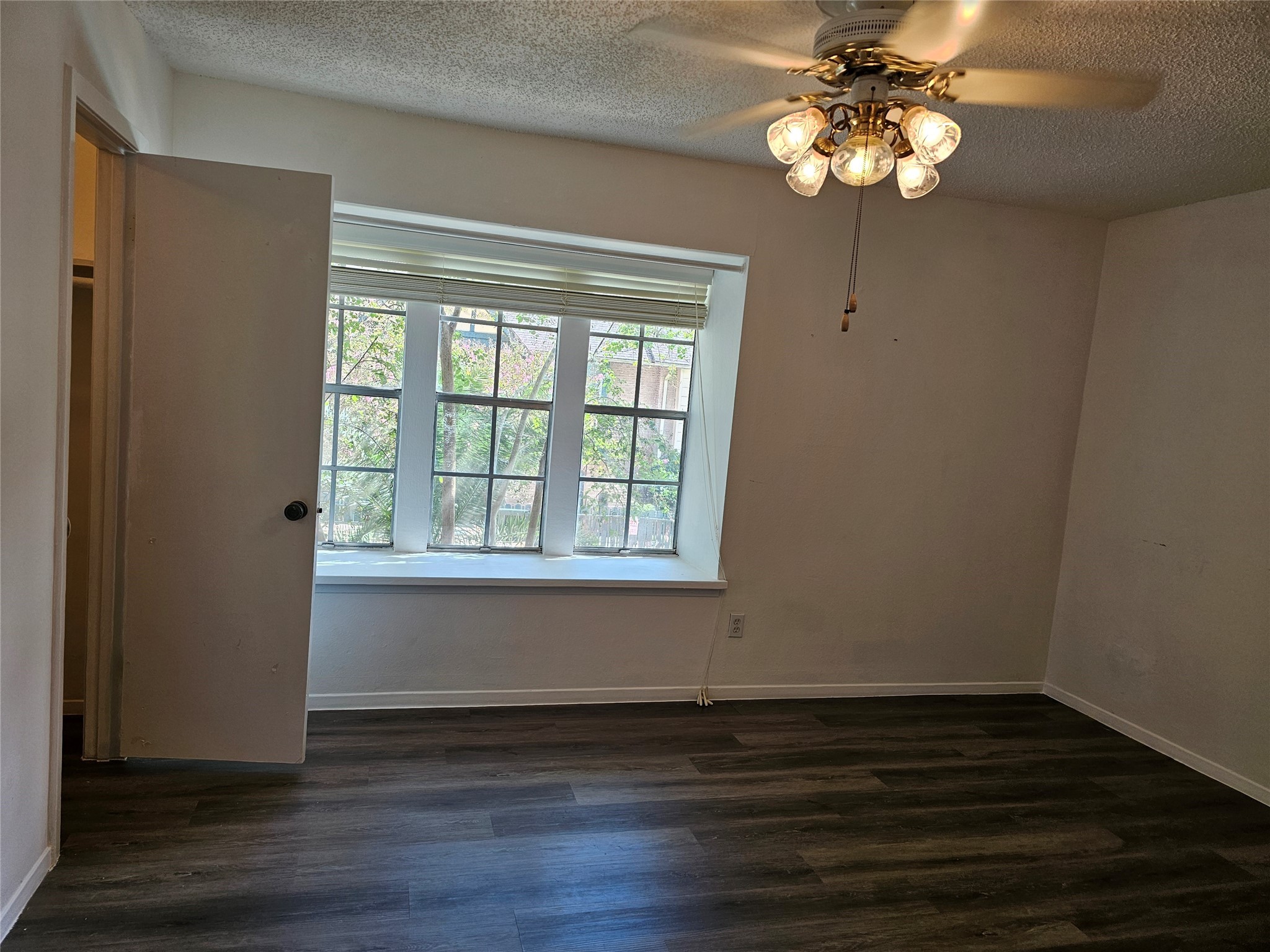 8287 Kingsbrook Road, Unit 268 Houston, TX 77024 - Photo 17 of 50 a view of a room with wooden floor and windows