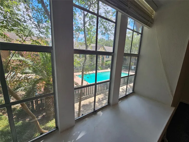 a view of an empty room with windows