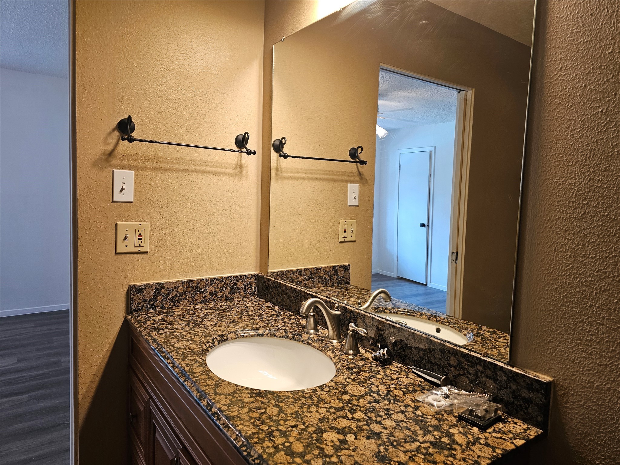 8287 Kingsbrook Road, Unit 268 Houston, TX 77024 - Photo 23 of 50 a bathroom with a granite countertop sink and a mirror