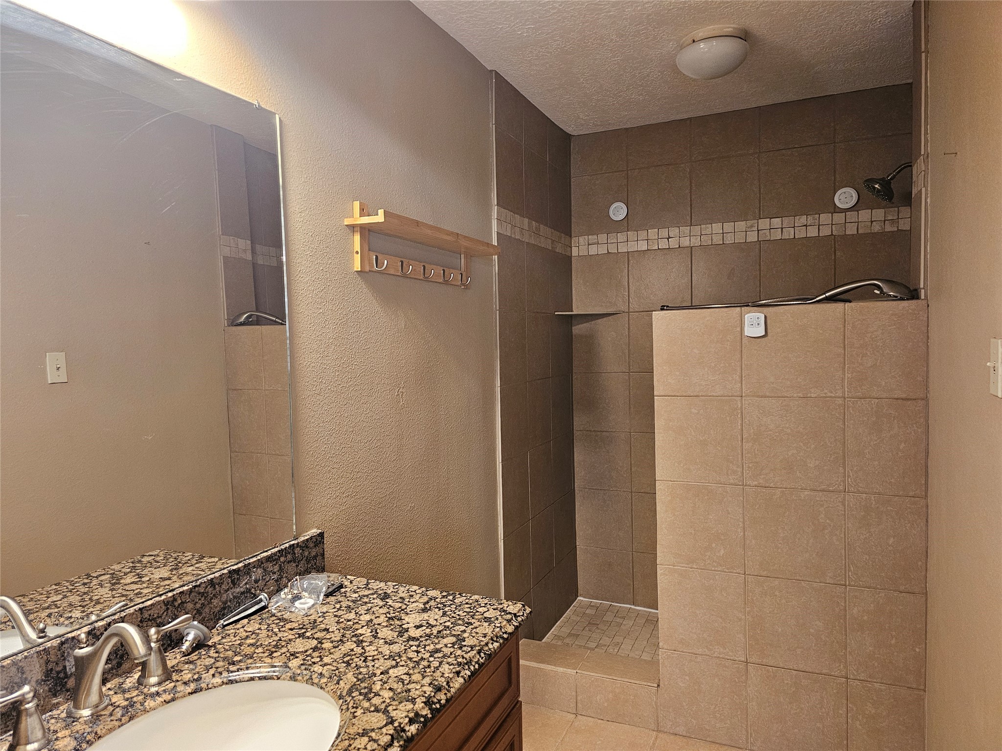 8287 Kingsbrook Road, Unit 268 Houston, TX 77024 - Photo 24 of 50 a bathroom with a sink and a mirror
