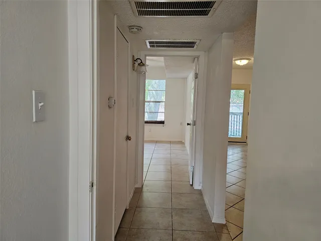 a view of a hallway with wooden shelves
