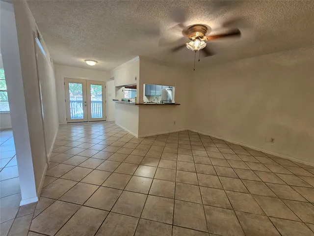 a view of a livingroom with a chandelier fan and furniture