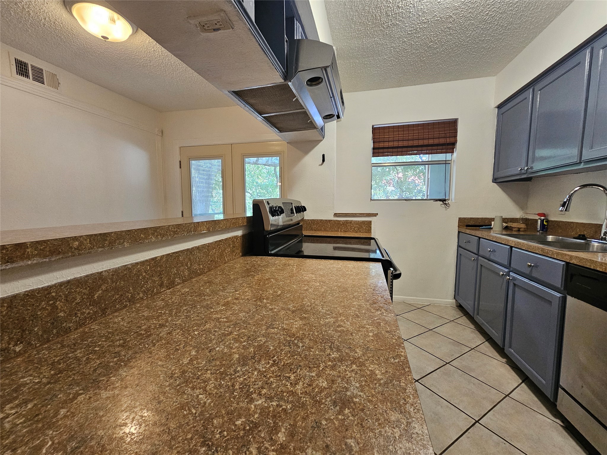 8287 Kingsbrook Road, Unit 268 Houston, TX 77024 - Photo 42 of 50 a kitchen with stainless steel appliances granite countertop a refrigerator and stove