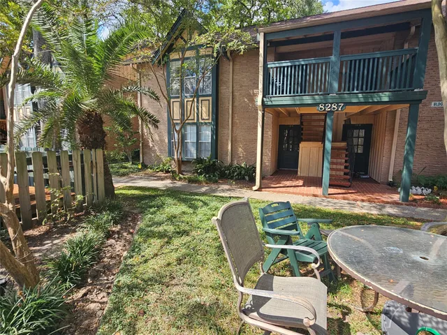 a view of a chair and tables in the patio