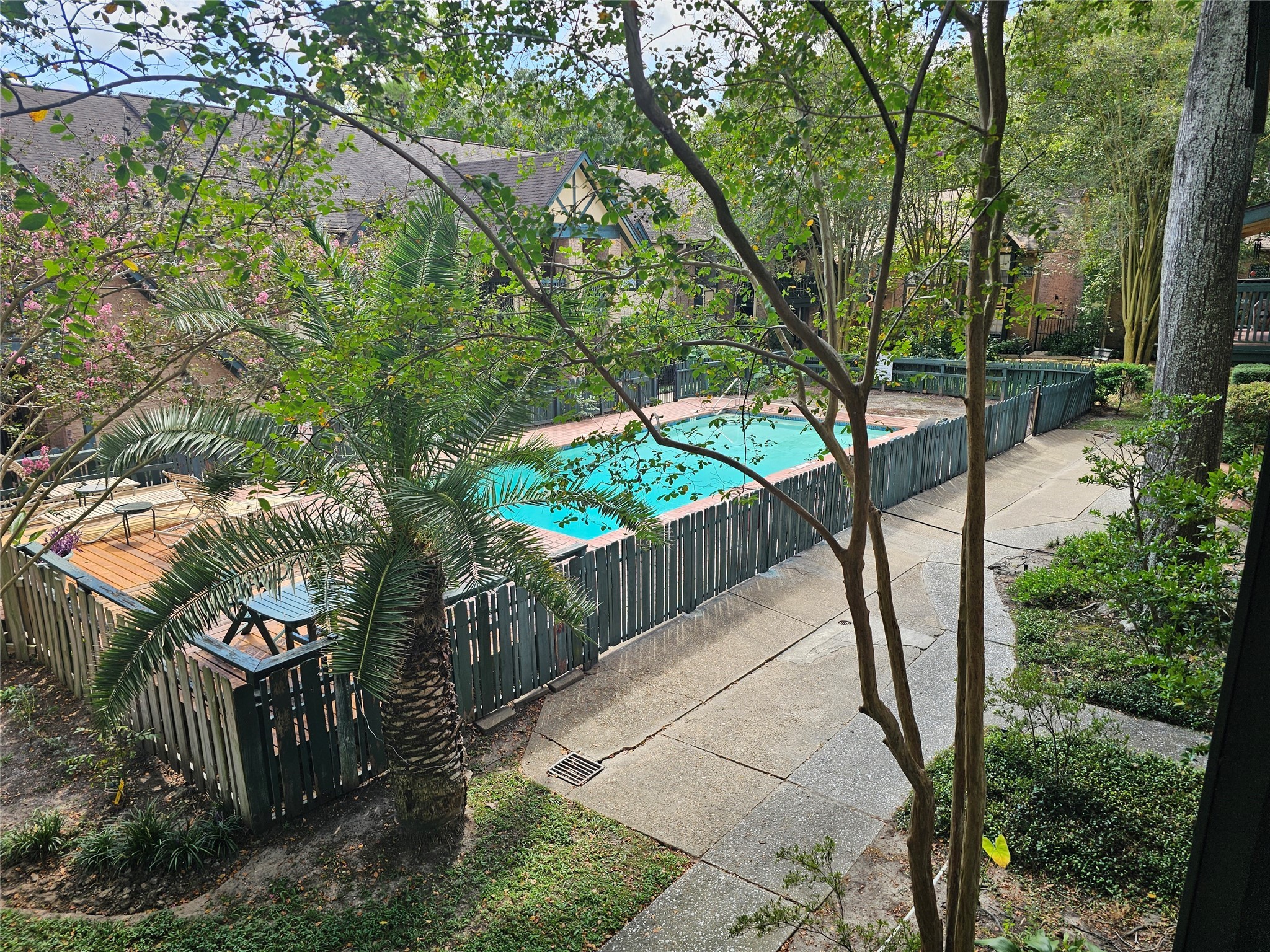 8287 Kingsbrook Road, Unit 268 Houston, TX 77024 - Photo 6 of 50 a view of a pathway with a bench in backyard