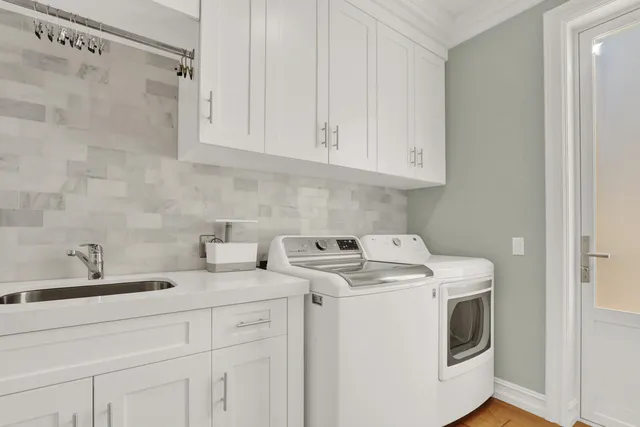 a bathroom with a sink a mirror a toilet and a window