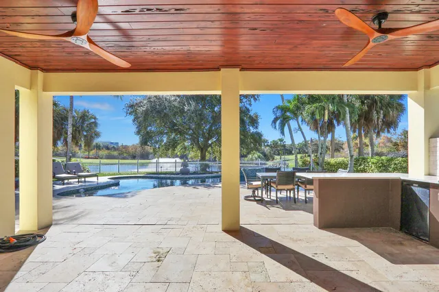 a porch with a table and chairs in front of it