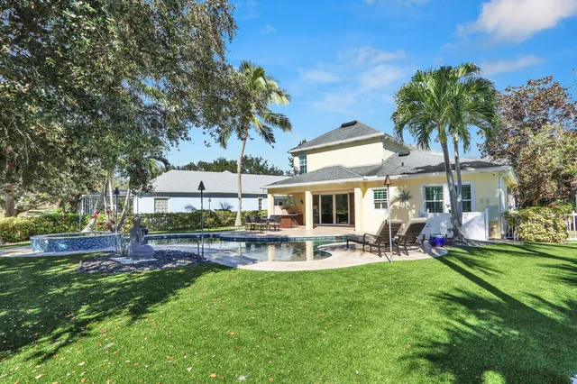 a view of a house with swimming pool and sitting area