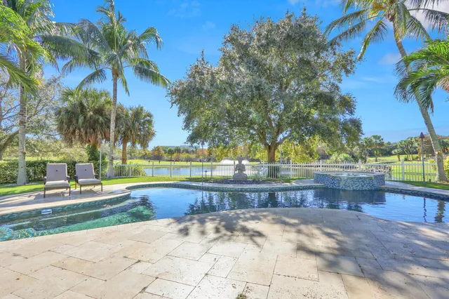 a view of swimming pool with a yard and sitting area