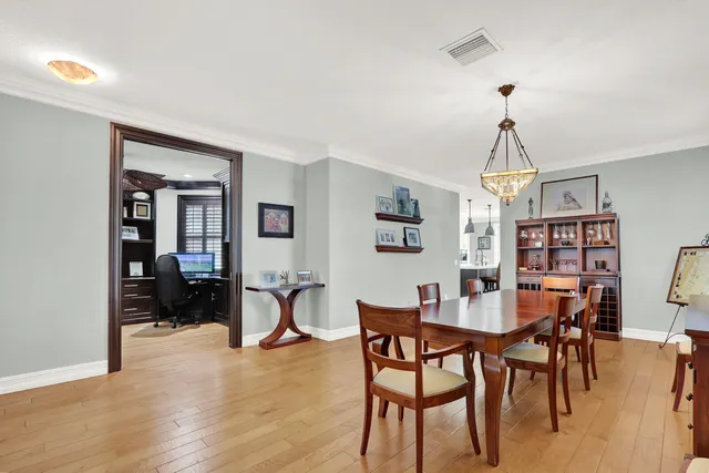a view of a a dining room with furniture window and wooden floor