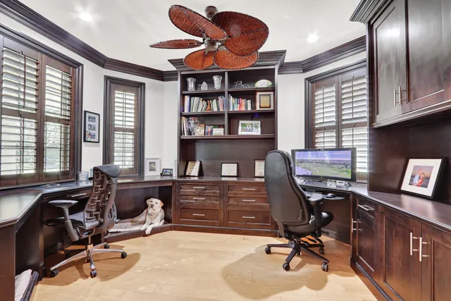 a view of a workspace with furniture and a window