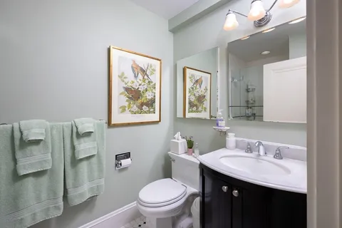 a bathroom with a toilet sink and mirror