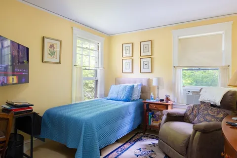 a bedroom with a bed and a couch