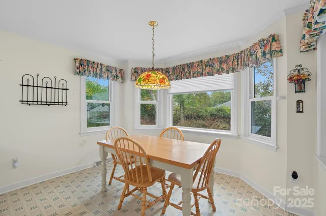a dining room with furniture a chandelier and wooden floor