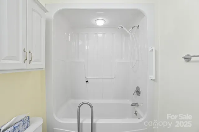 a bathroom with a bathtub a sink a toilet and a mirror