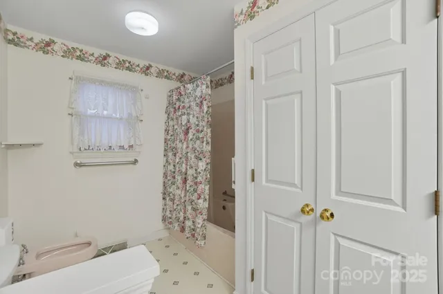 a bathroom with a toilet a sink and shower