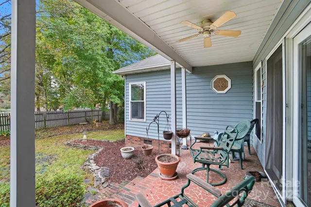 a view of a patio with table and chairs and potted plants
