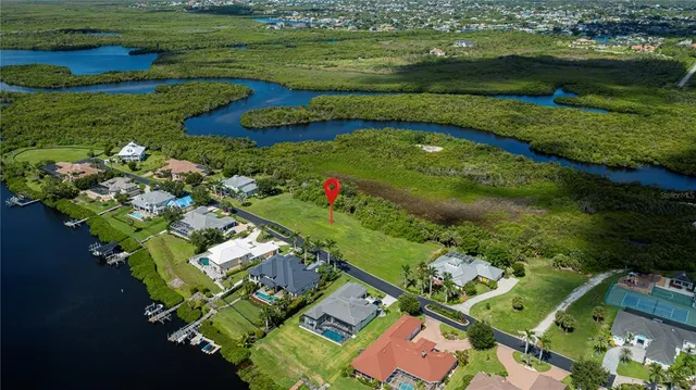 a front view of a house with a yard and potted plants