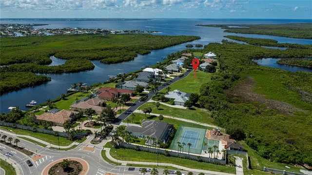 a view of a swimming pool with a table and chairs under an umbrella