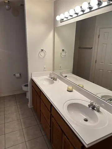 a bathroom with a sink double vanity and a mirror