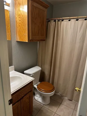 a white toilet sitting next to a small sink