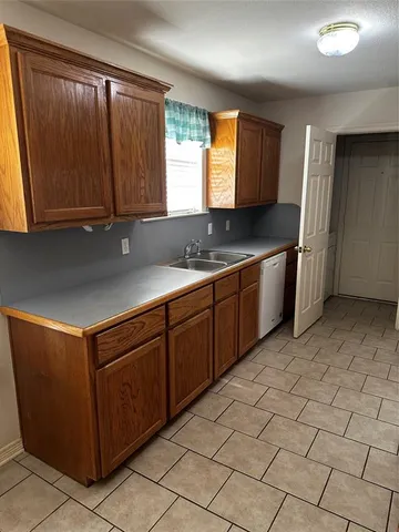 a kitchen with stainless steel appliances granite countertop a sink and a stove
