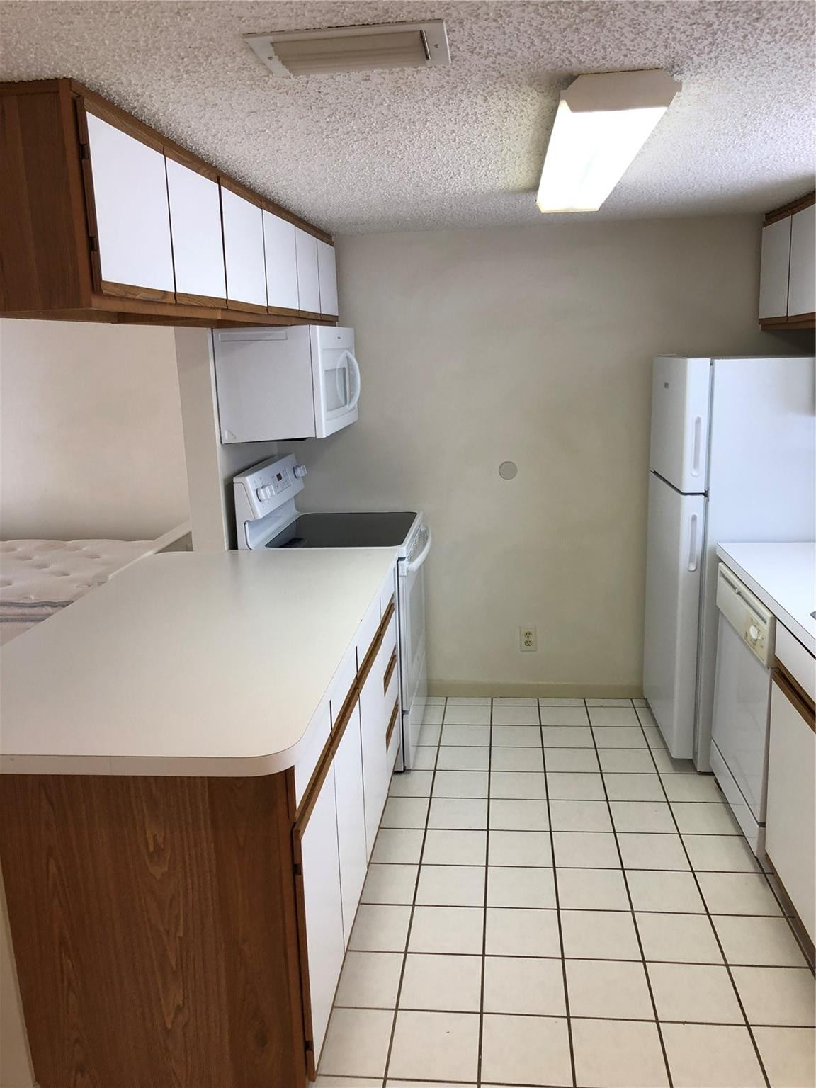 6331 La Costa Drive, Unit G Boca Raton, FL 33433 - Photo 2 of 12 a kitchen with a sink a refrigerator and cabinets