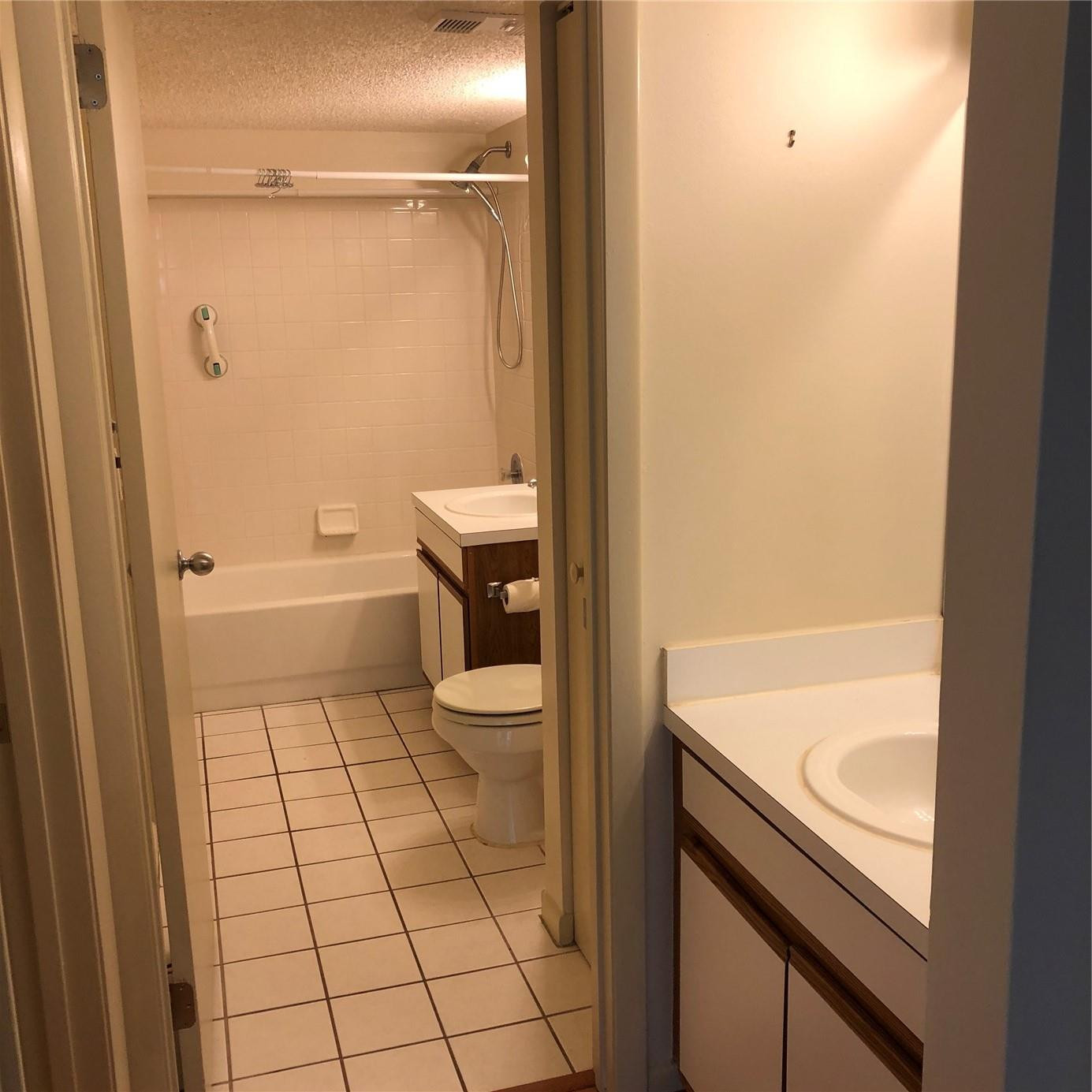 6331 La Costa Drive, Unit G Boca Raton, FL 33433 - Photo 4 of 12 a bathroom with a sink a toilet and shower