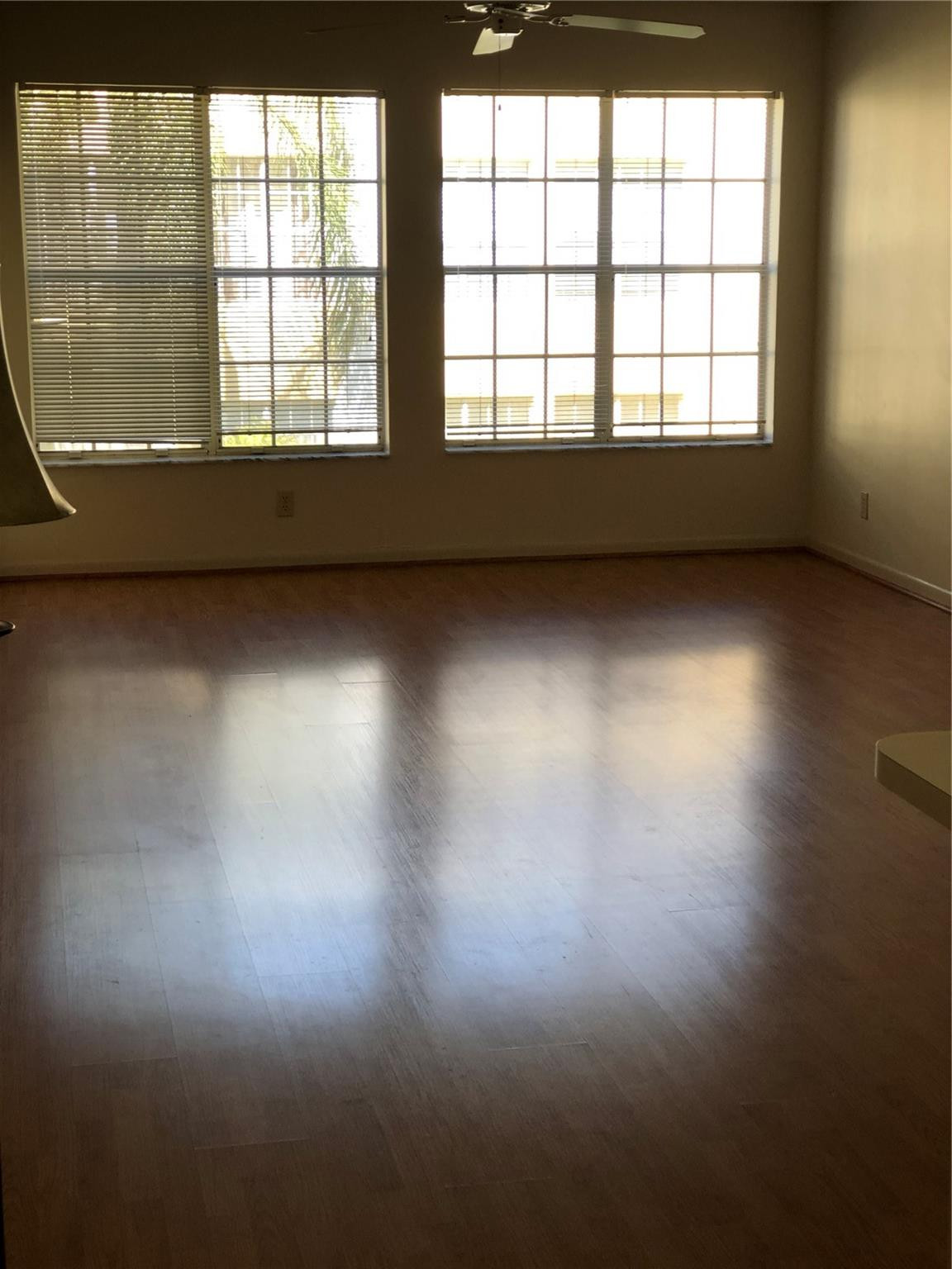 6331 La Costa Drive, Unit G Boca Raton, FL 33433 - Photo 6 of 12 an empty room with wooden floor and windows