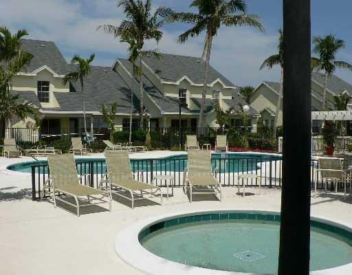 6331 La Costa Drive, Unit G Boca Raton, FL 33433 - Photo 10 of 12 a view of a patio with a table chairs potted plants and a palm tree