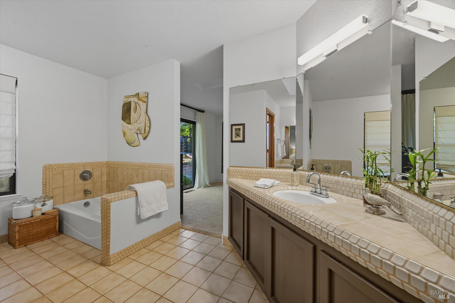 246 Zinfandel Road Healdsburg, CA 95448 - Photo 21 of 50 a spacious bathroom with a granite countertop sink and a mirror