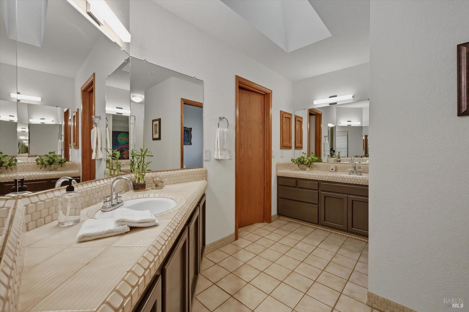 246 Zinfandel Road Healdsburg, CA 95448 - Photo 22 of 50 a spacious bathroom with a granite countertop sink mirror and shower