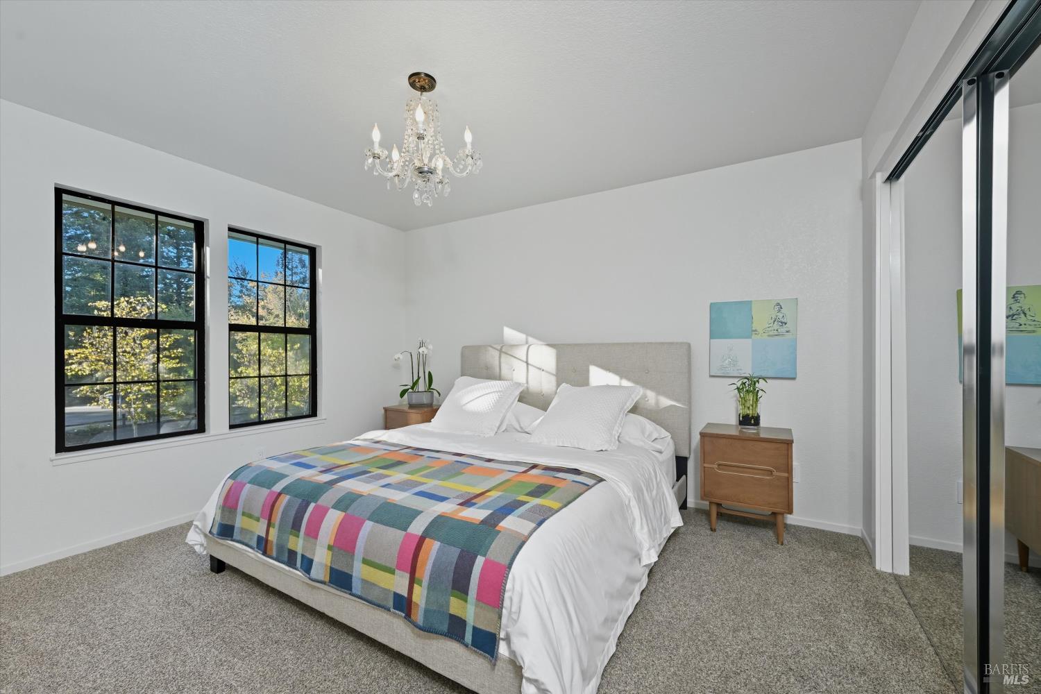 246 Zinfandel Road Healdsburg, CA 95448 - Photo 29 of 50 a bedroom with a large bed and a chandelier