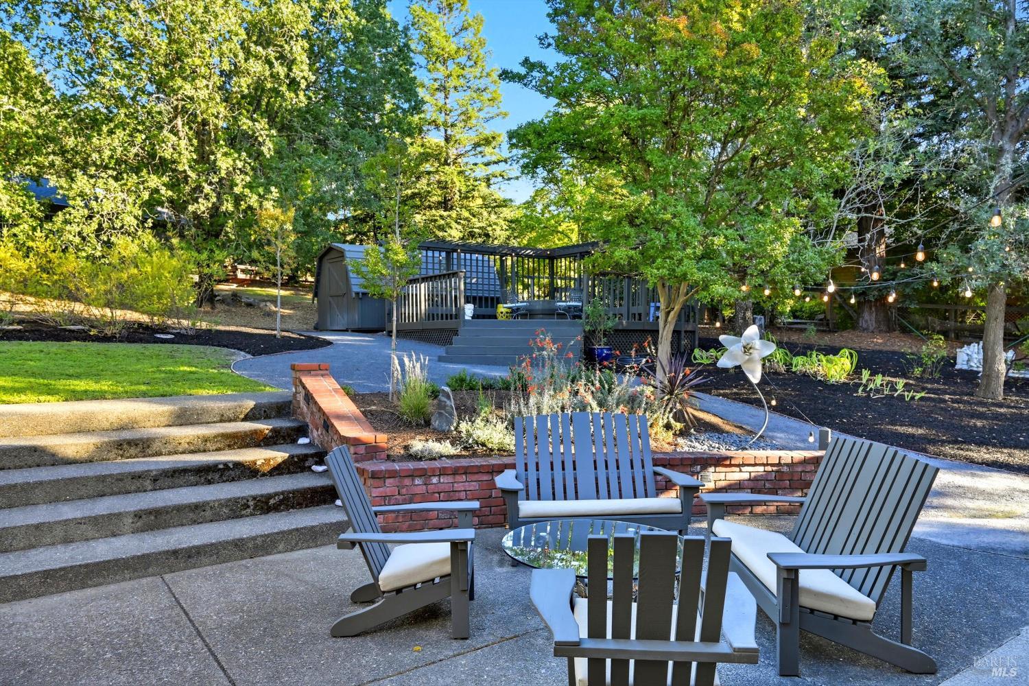 246 Zinfandel Road Healdsburg, CA 95448 - Photo 34 of 50 a view of a patio with table and chairs and potted plants and large trees