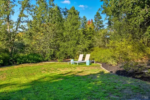 a view of a backyard with sitting area