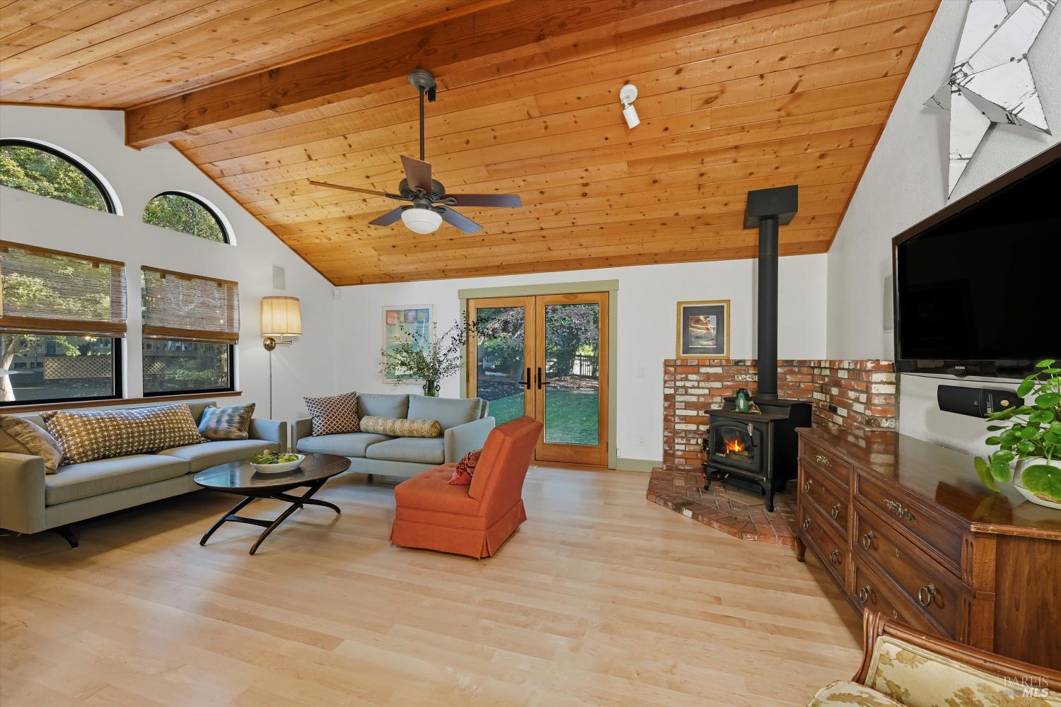 246 Zinfandel Road Healdsburg, CA 95448 - Photo 8 of 50 a living room with furniture a flat screen tv and floor to ceiling window