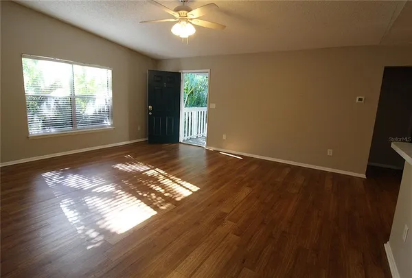 wooden floor in an empty room with a window