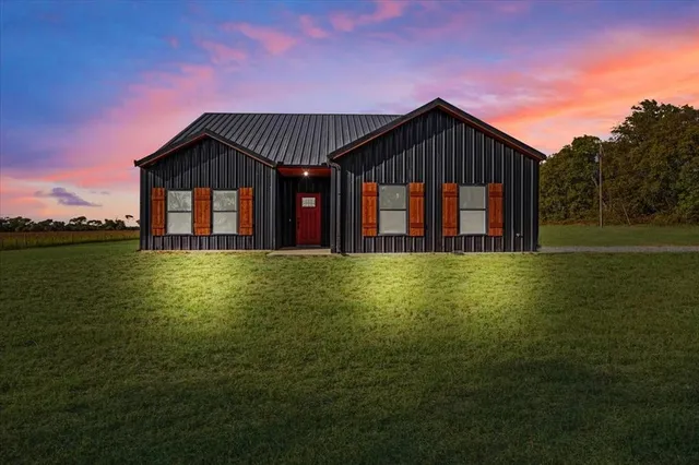 a front view of house with yard and green space