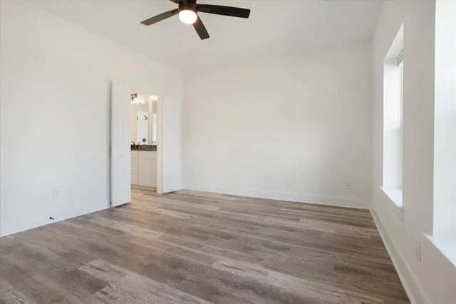 a kitchen with granite countertop a sink cabinets and wooden floor
