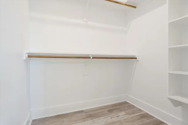 a view of a kitchen with white cabinets