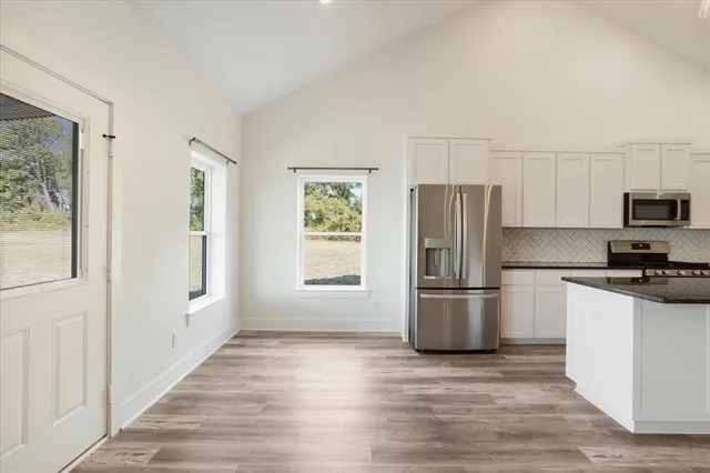 a kitchen with a sink a stove and cabinets