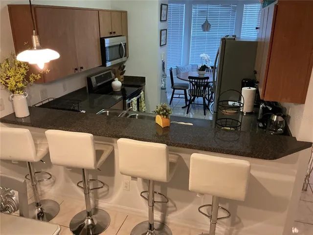 a kitchen with a table chairs and a dining table
