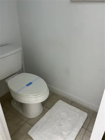 a white toilet sitting next to a white sink
