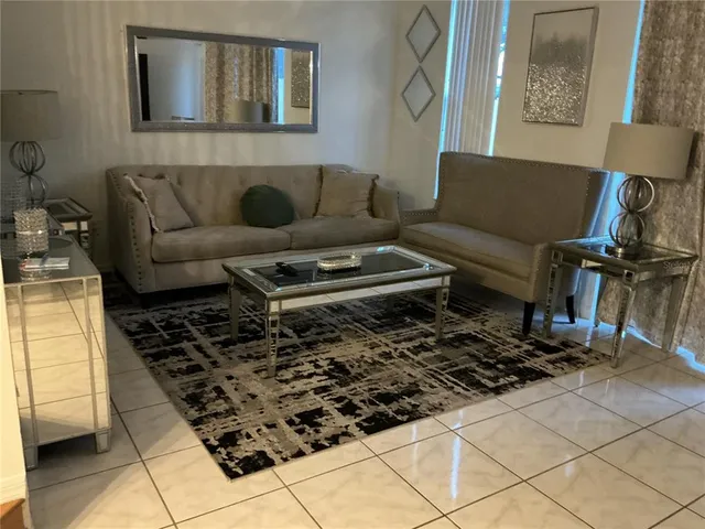 a living room with furniture and a rug