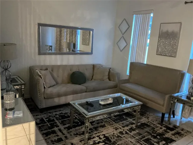 a living room with furniture and a rug