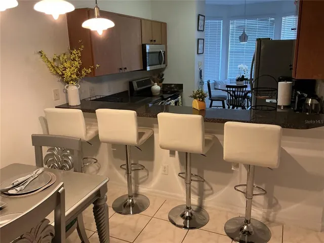a living room with furniture a flat screen tv and a lamp