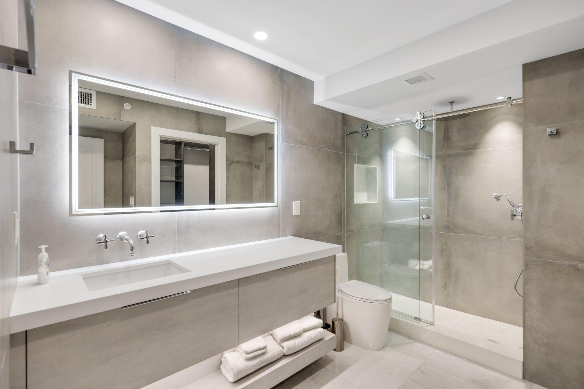 100 Southeast 5th Avenue, Unit 106 Boca Raton, FL 33432 - Photo 36 of 81 a bathroom with a sink a toilet and shower