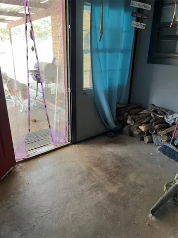 a view of a room with a flat tv screen and a window