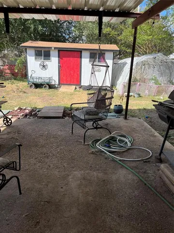 a view of a lounge chair in the small yard